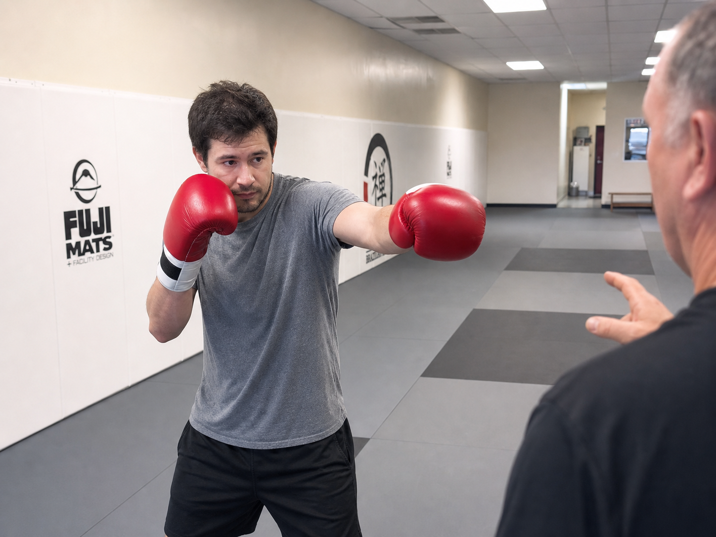 A first-day adult kickboxing student learning the jab at ZEN