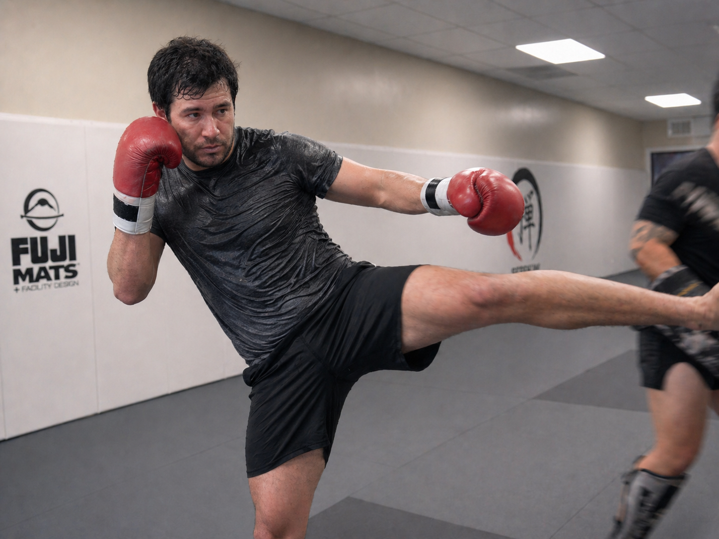 Experienced adult kickboxing student rolling six rounds at ZEN after ninety days of training