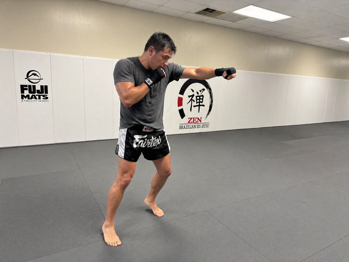 Adult student shadow boxing between rounds at ZEN
